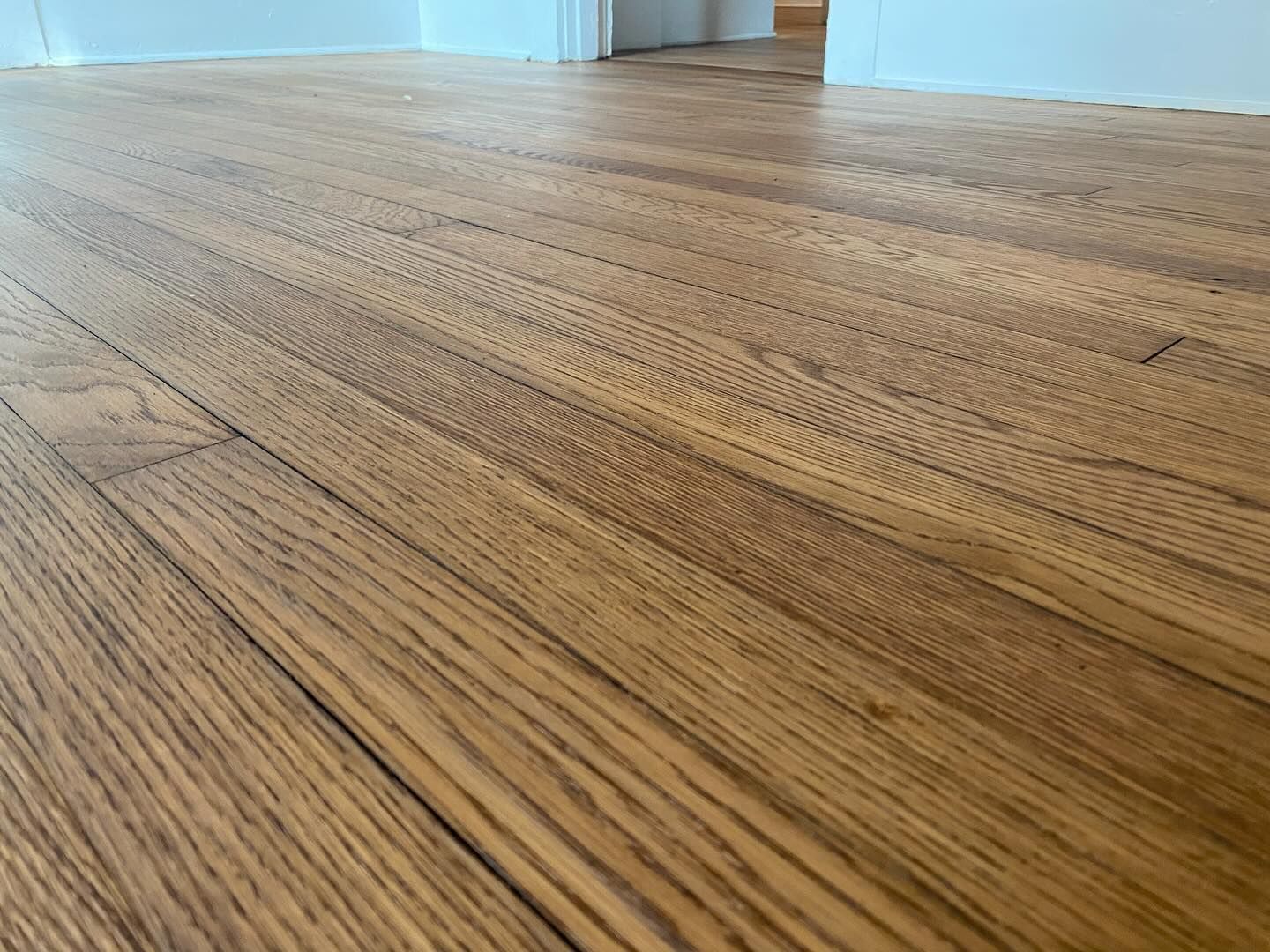 A close up of a wooden floor in a room.