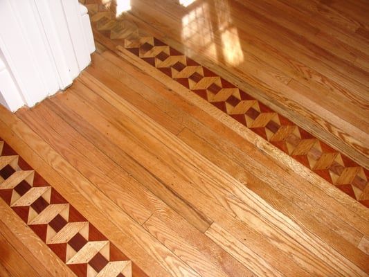 A wooden floor with a geometric pattern on it