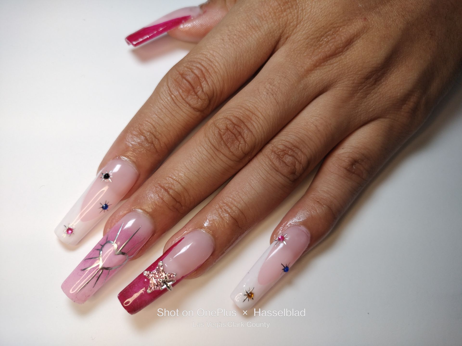 A close up of a woman's hand with long nails