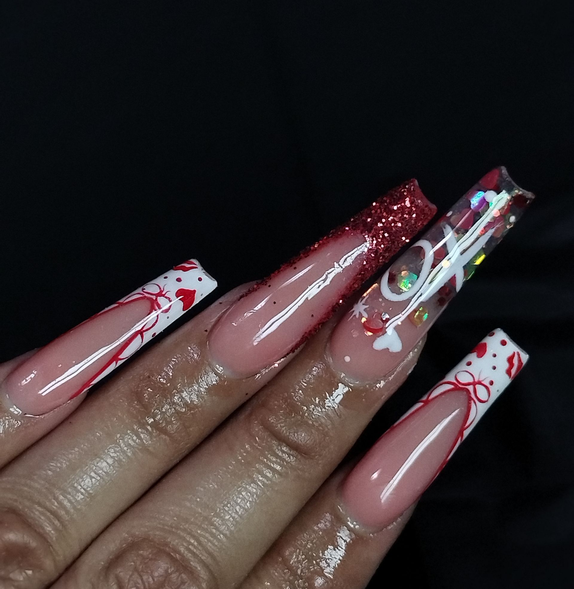 A close up of a woman's hand with long nails