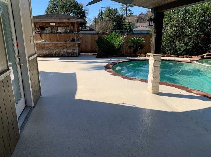 Backyard with a pool, concrete patio, and an outdoor bar.
