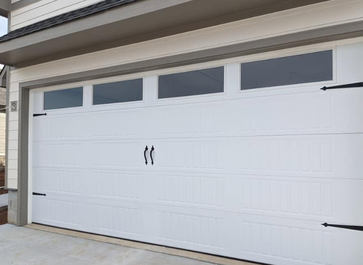 White double garage door with small windows on a house exterior