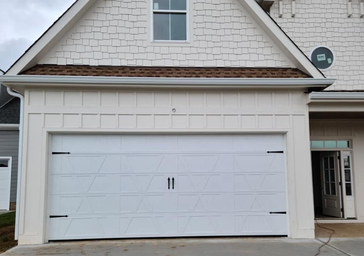 White two-car garage on a house with a side entrance and satellite dish