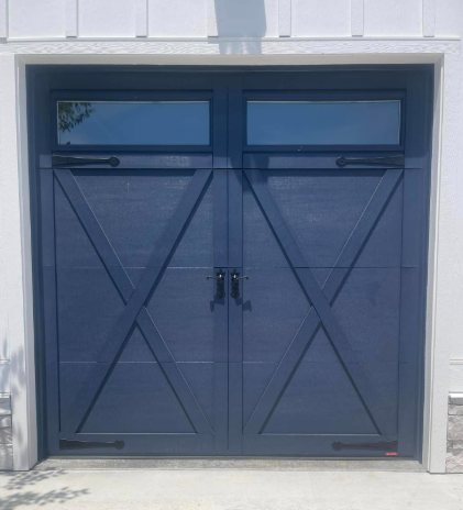 Blue double garage door with X-braced panels and small windows at the top