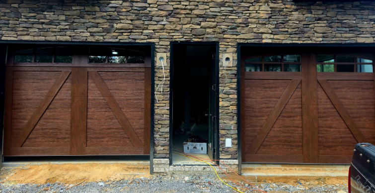 Wooden double garage doors with a central open doorway on a brick facade