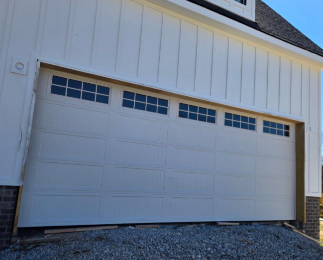White garage door with small windows on a house exterior