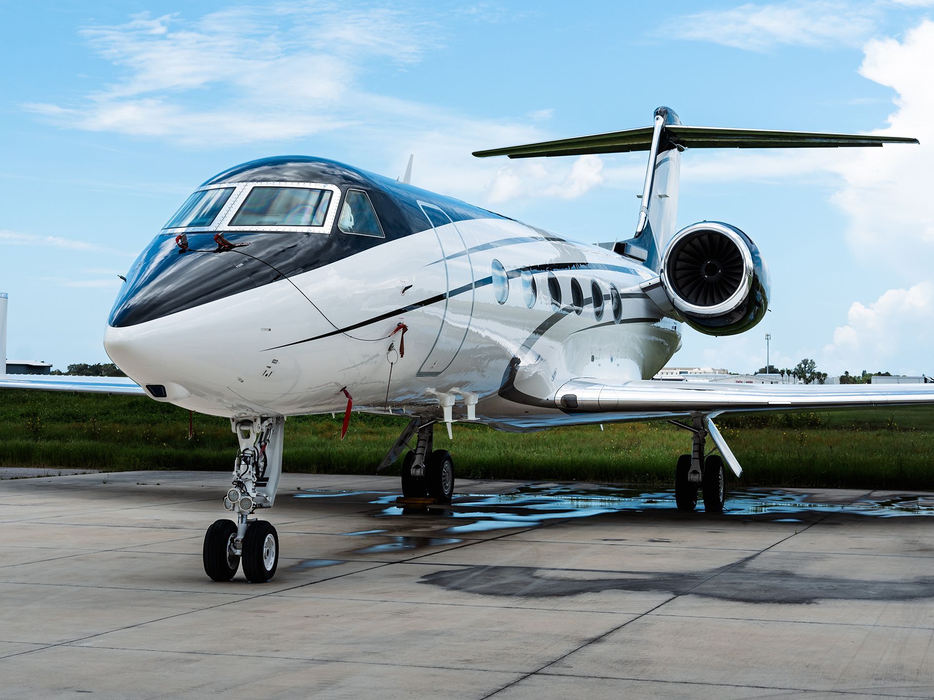 A small private jet is parked on a runway.