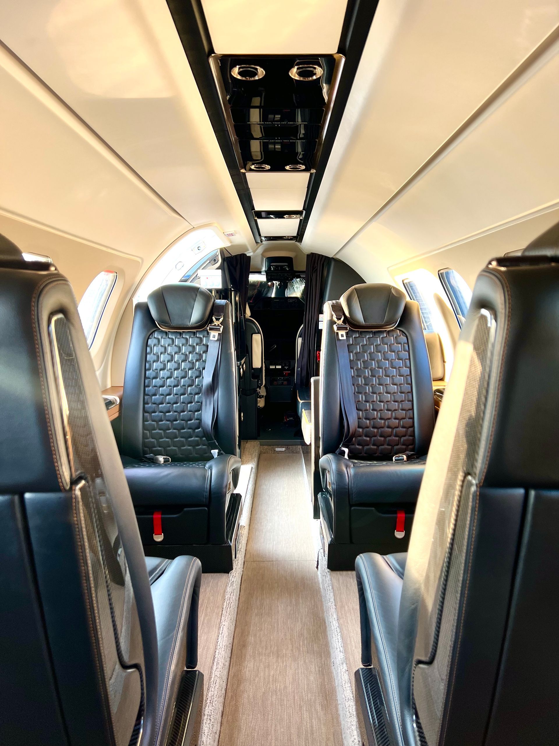 The inside of a private jet with a lot of seats