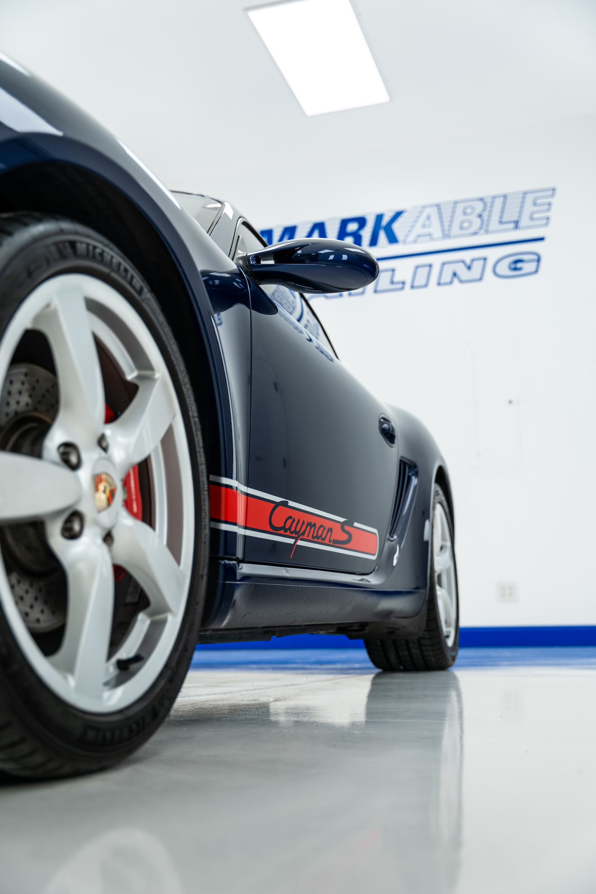 A close up of a car's wheel in a garage.