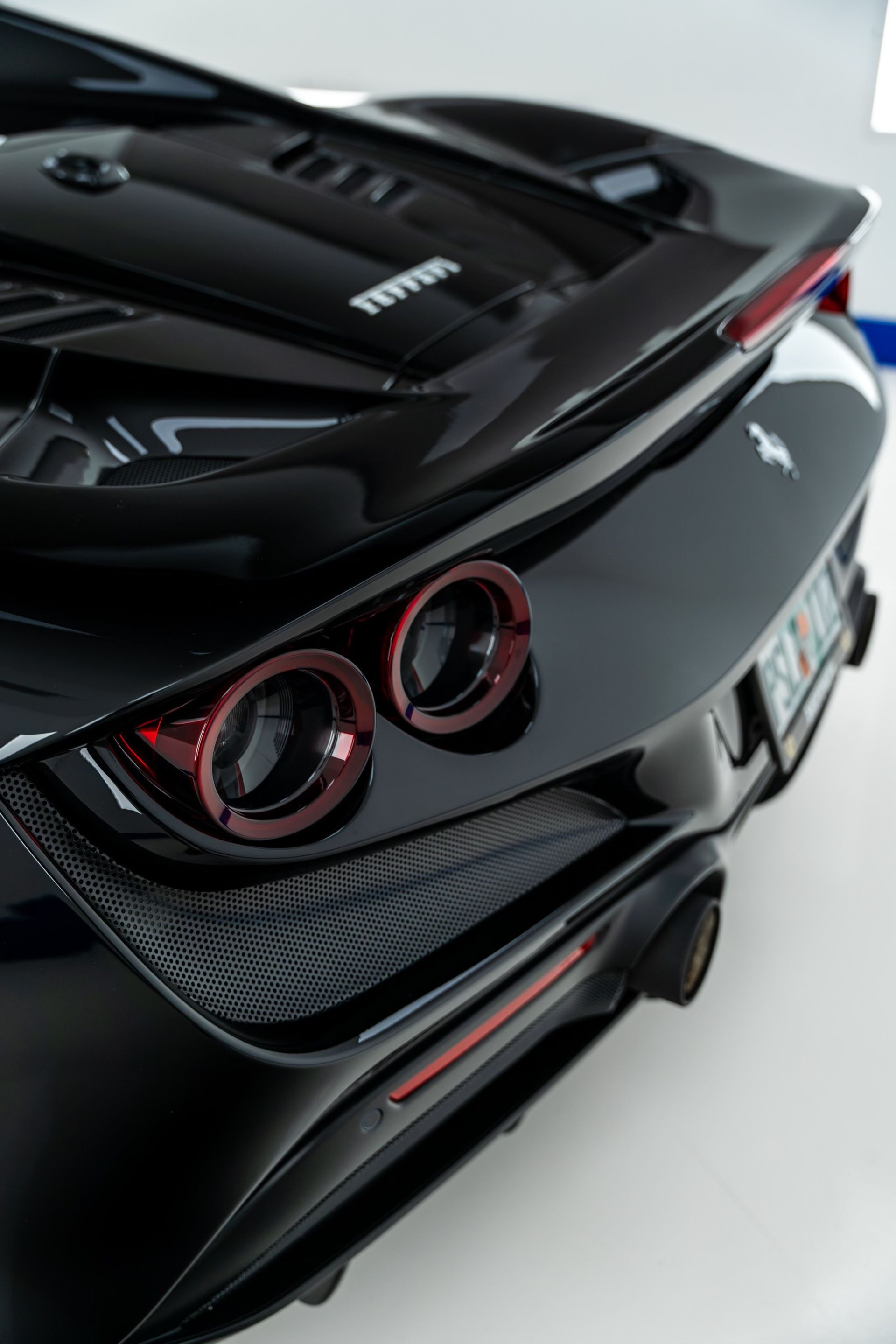 The rear end of a black ferrari sports car is shown.