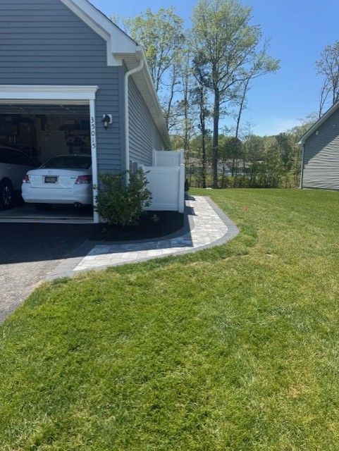 A car is parked in a garage next to a house.