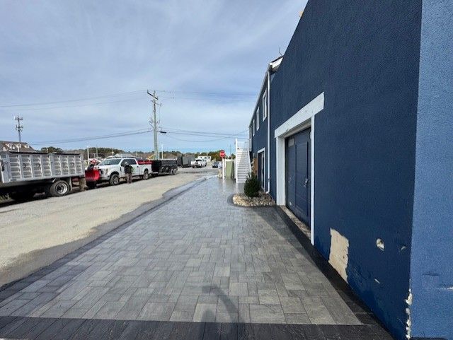A row of trucks are parked in front of a blue building