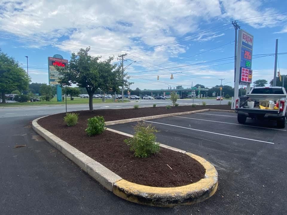 A truck is parked in a parking lot next to a gas station.