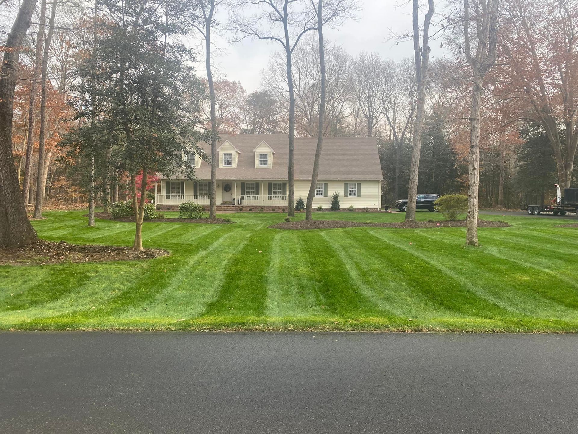 A house with a lush green lawn in front of it.