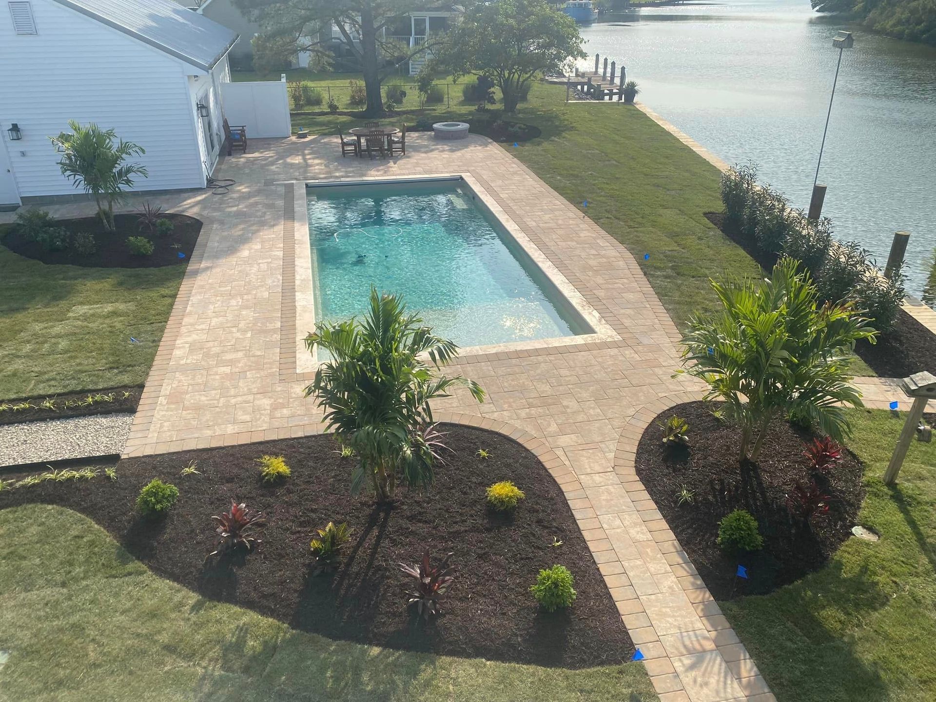 An aerial view of a large swimming pool in a backyard.