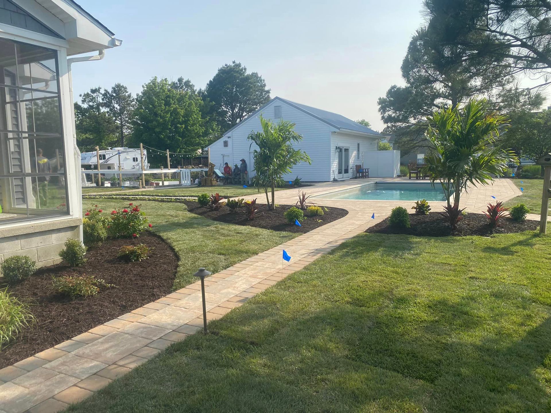 There is a swimming pool in the backyard of a house.