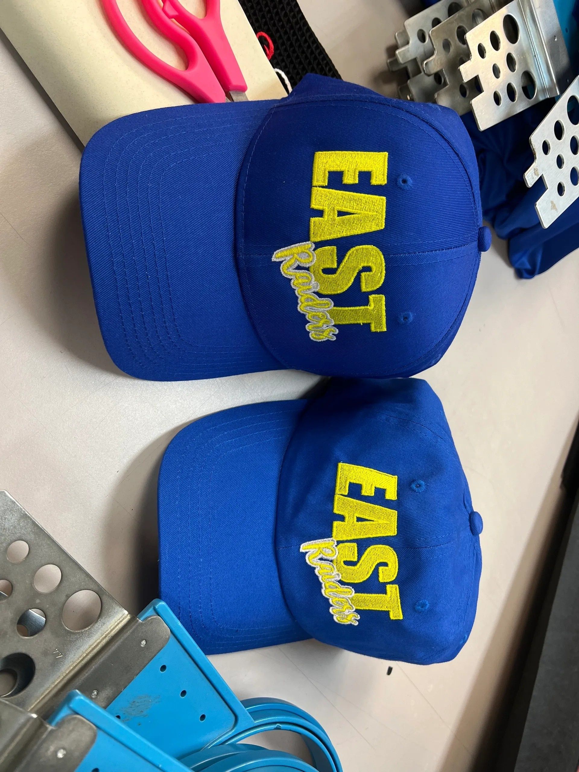 Two blue caps with yellow 