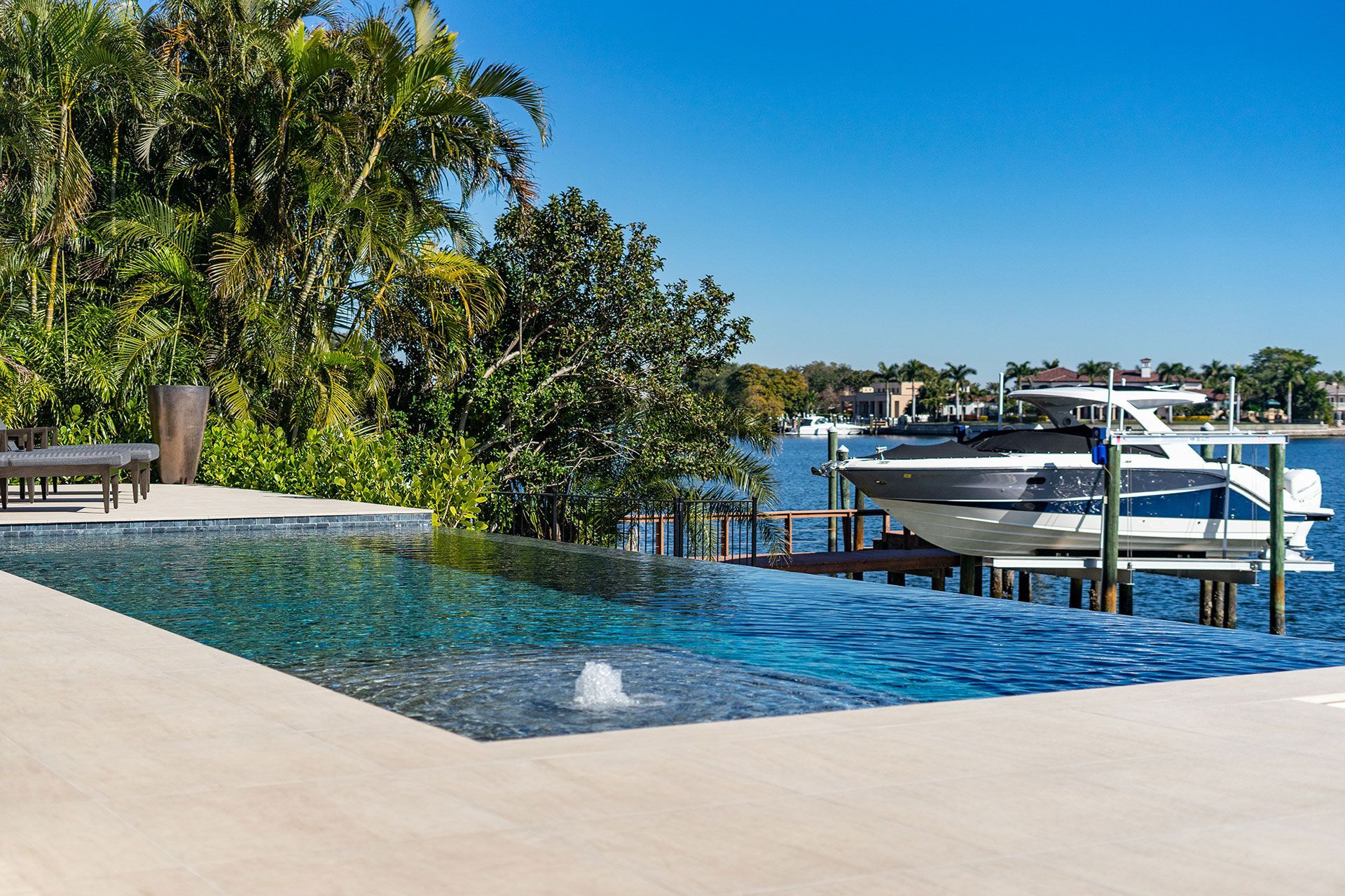 infinity pool beside a speed boat