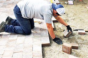 man assembles concrete blocks