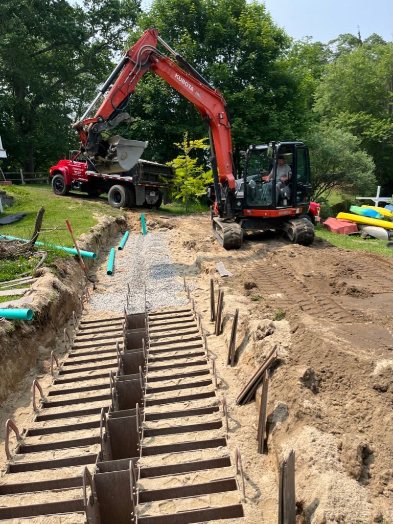 Construction site with two excavators digging a trench.