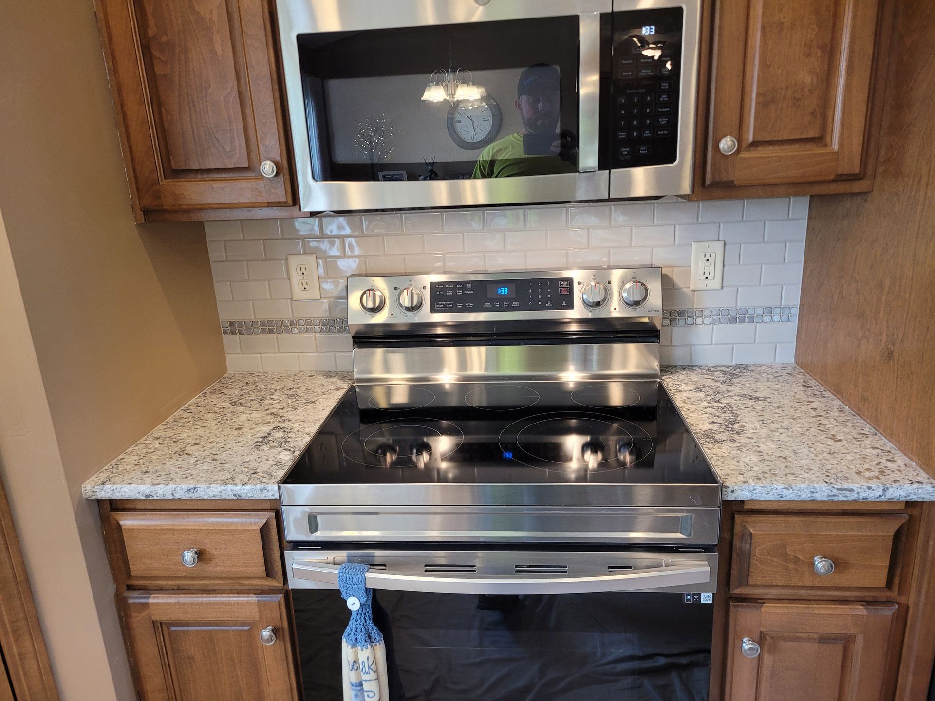 Kitchen with wooden cabinets, stainless steel appliances, and granite countertops.