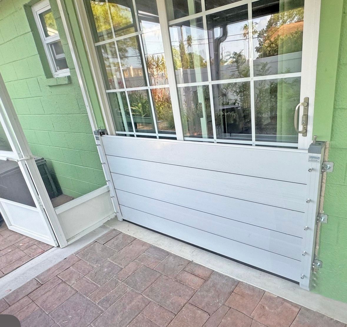 Green house with a flood barrier on the door