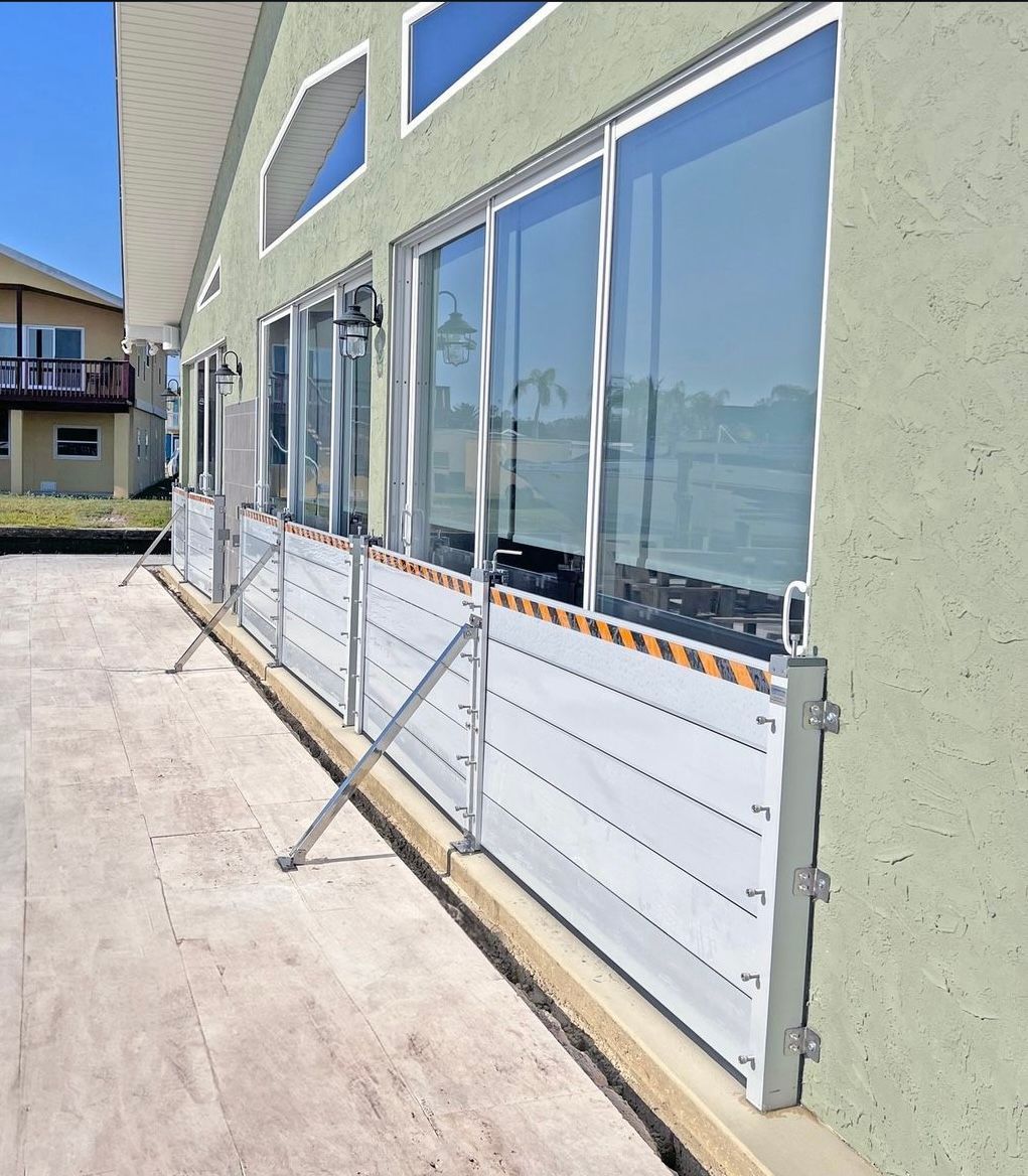 Patio balcony with large windows and white flood barriers