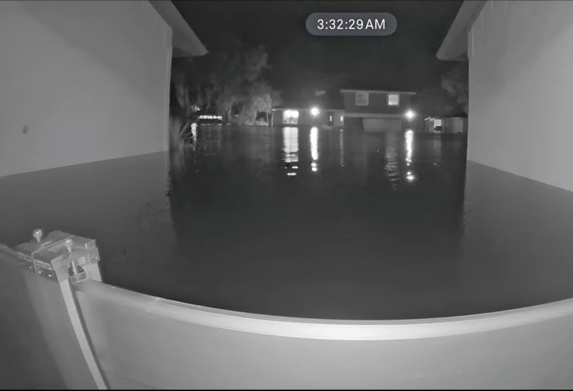 Flooded street at night seen from a doorway