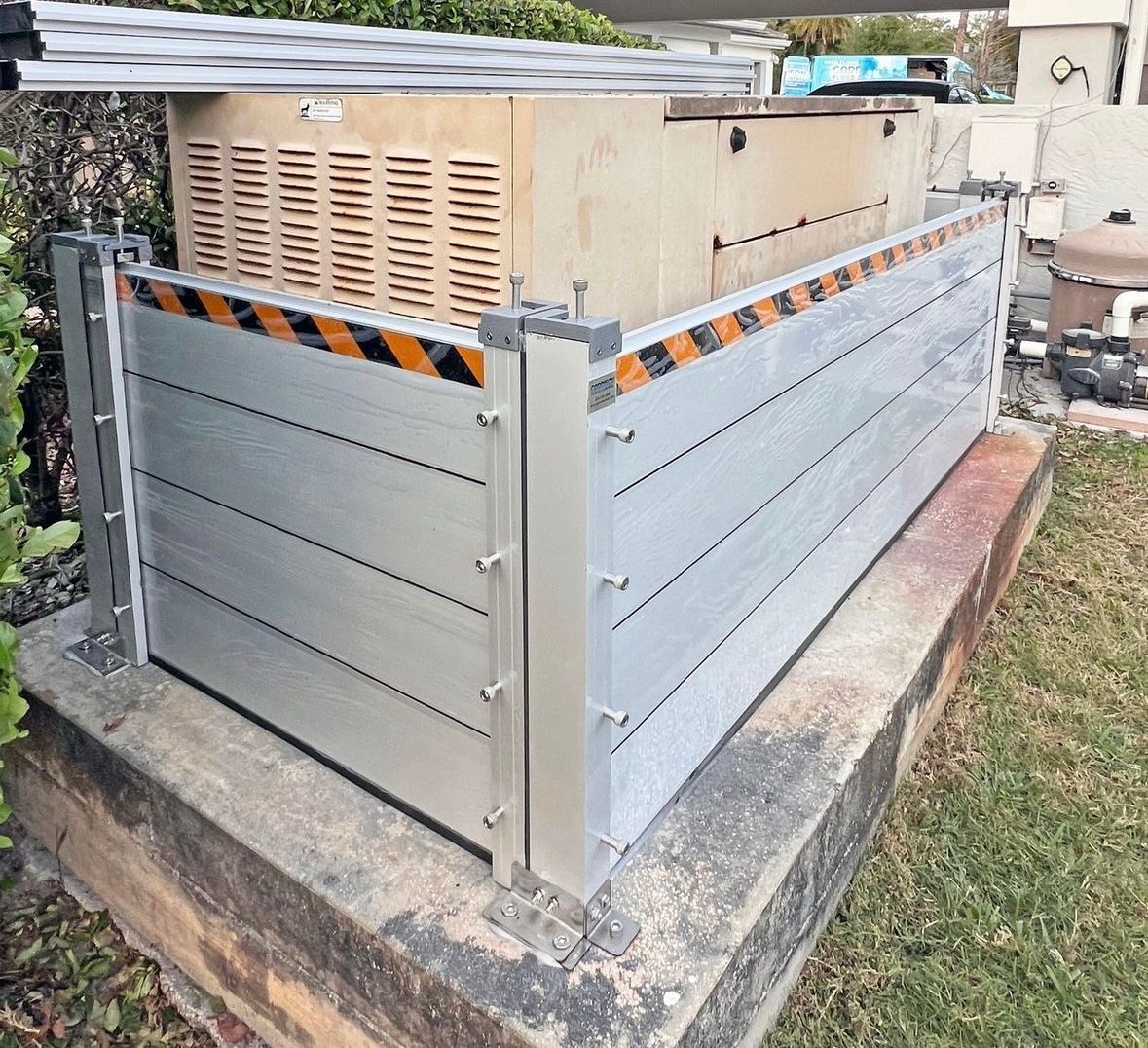 Outdoor flood barrier around a generator