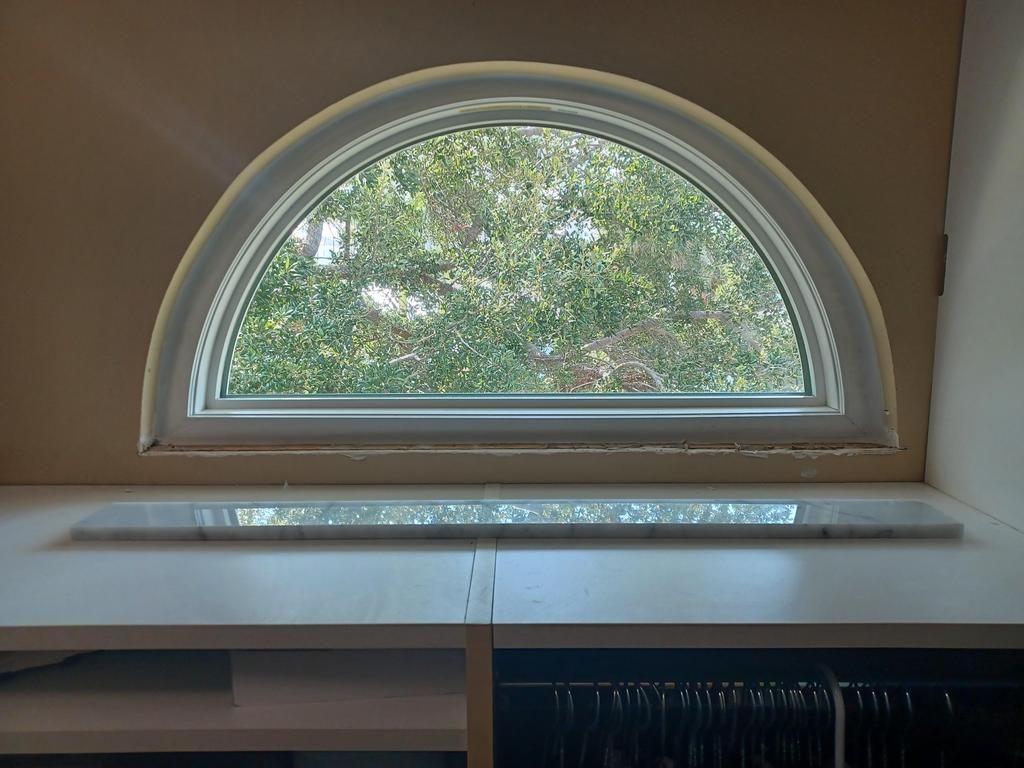 Arched window above a cabinet