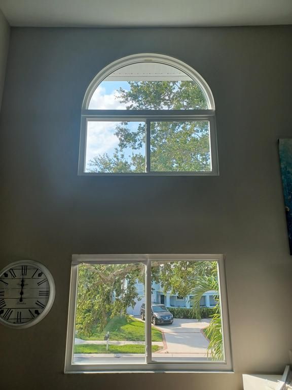 Tall wall with arched and rectangular windows