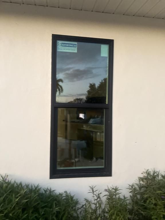 Black-framed window in a beige wall