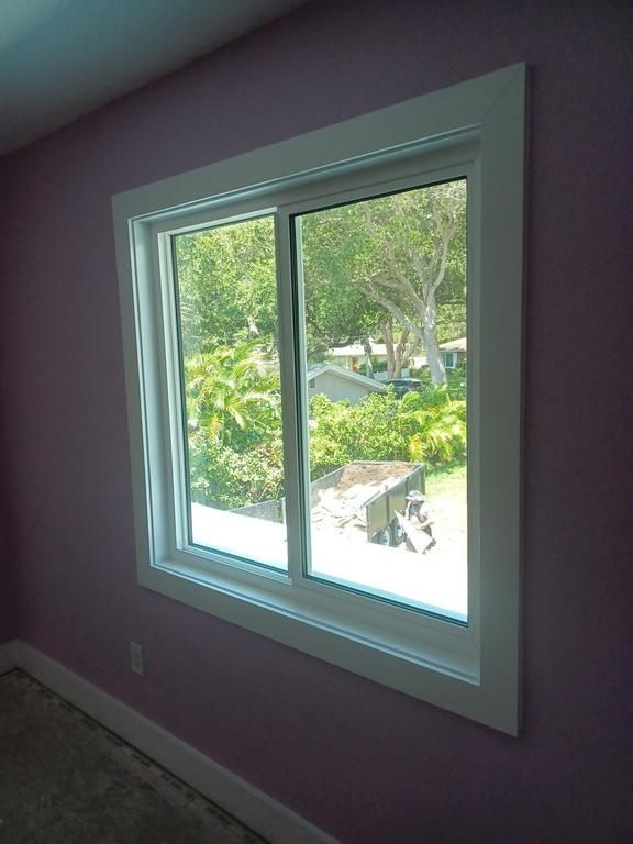 White-framed window in a purple room