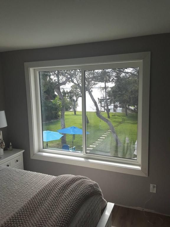 Bedroom window overlooking a grassy yard