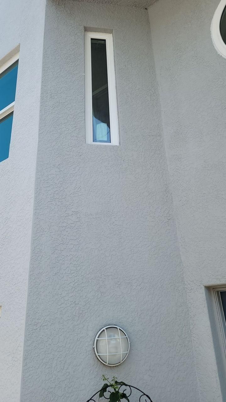 Gray building exterior with a narrow vertical window