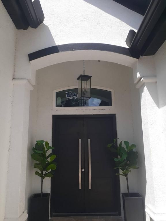 Covered entrance with dark double doors