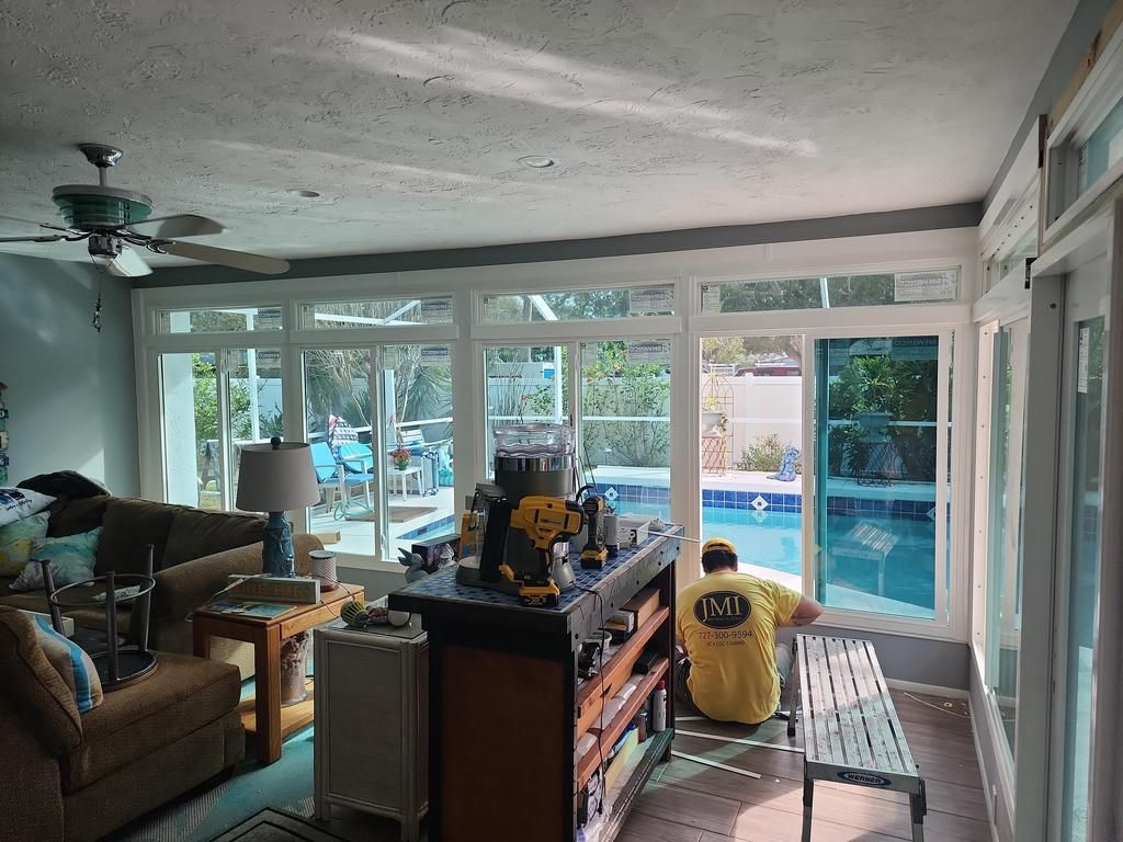 Bright living room with a worker installing large windows