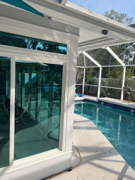 Poolside patio with a sliding glass windows