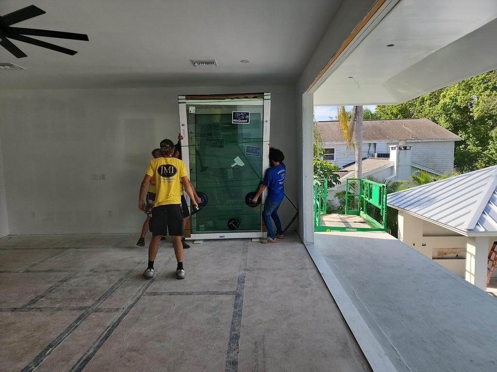 Workers moving glass panels