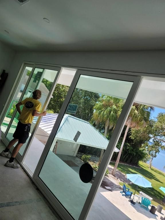 Man closing huge glass sliding doors