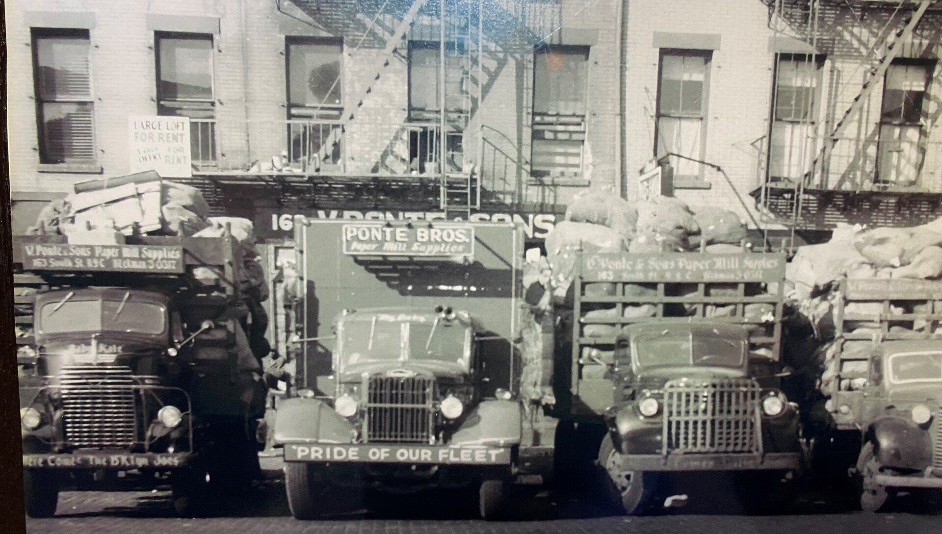 a black in white photo of a building taken long ago in the past