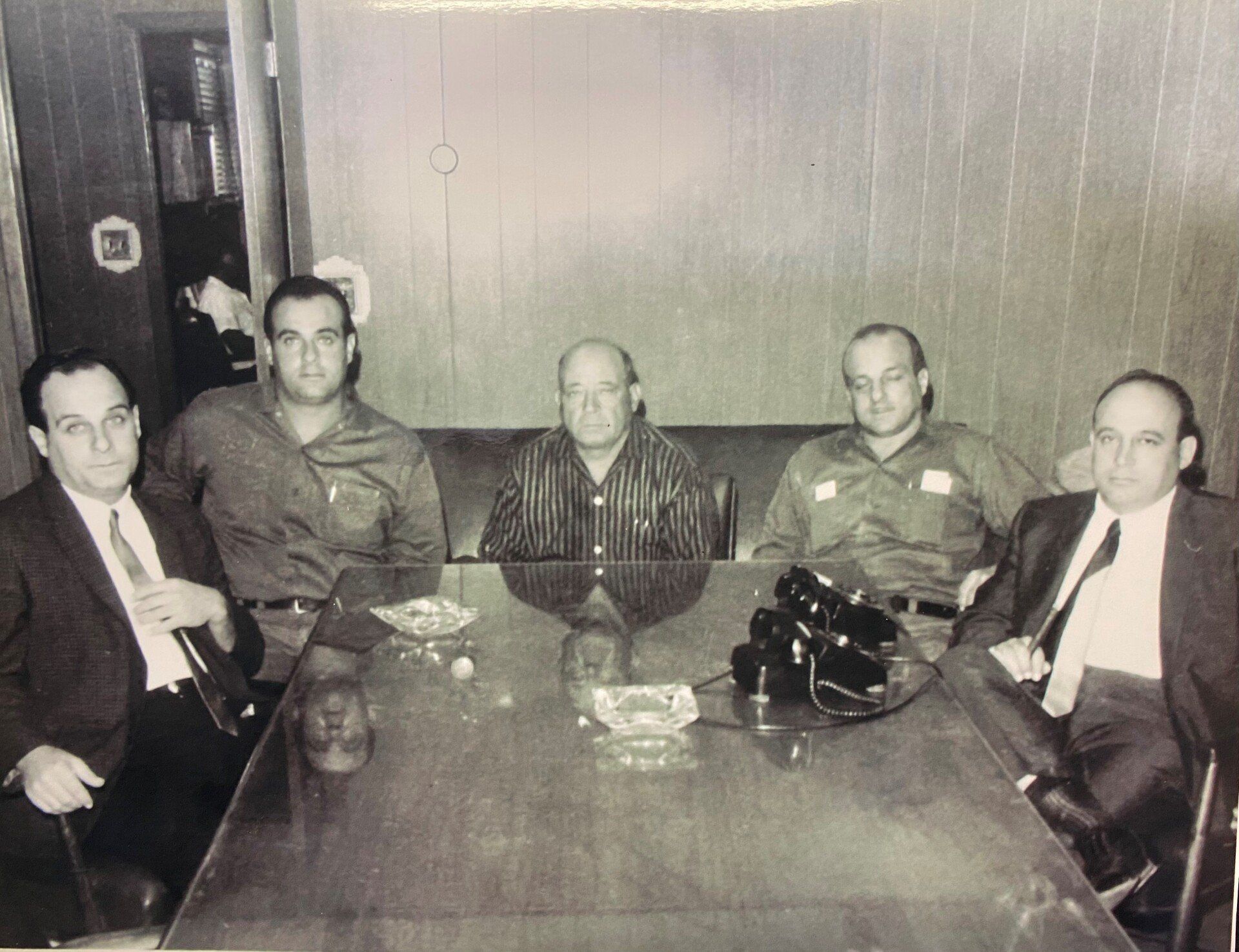a black in white photo of a group of people taken a long ago in the past