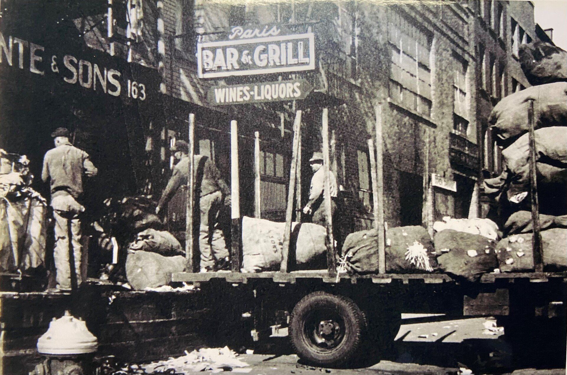 a black in white photo of the storefront taken a long ago in the past
