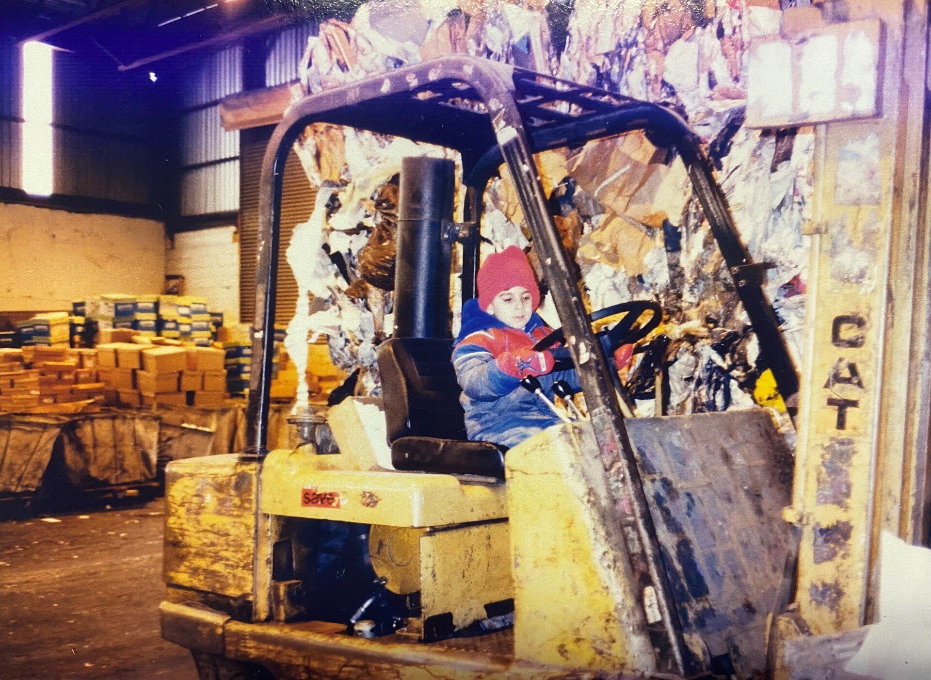 A classic picture of a lift being driven by a boy