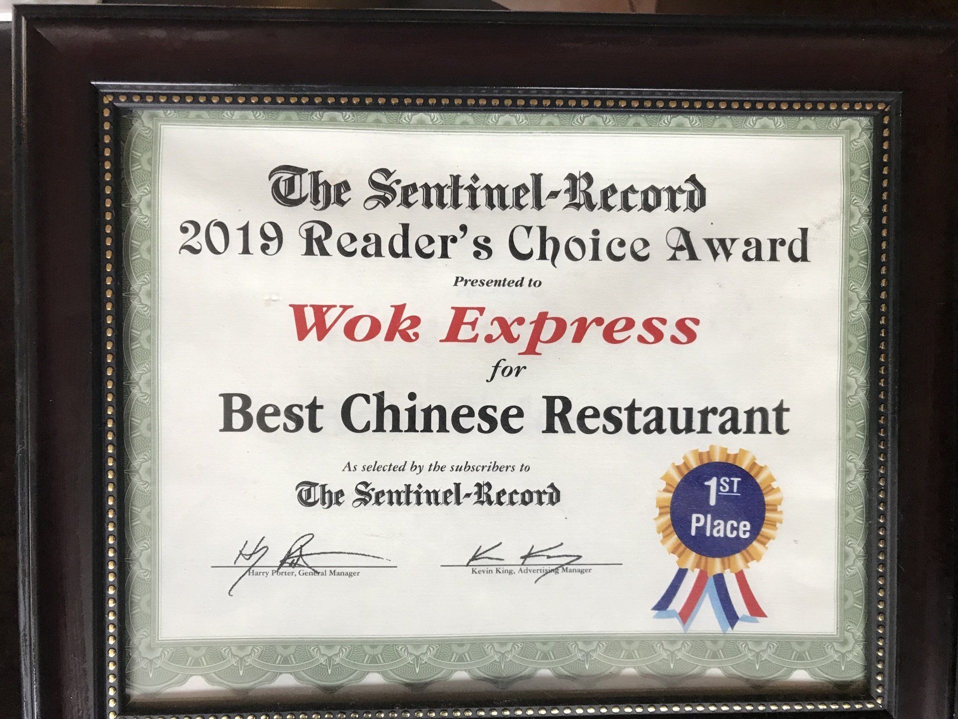 A certificate that says the sentinel record 2019 reader 's choice award for wok express for best chinese restaurant