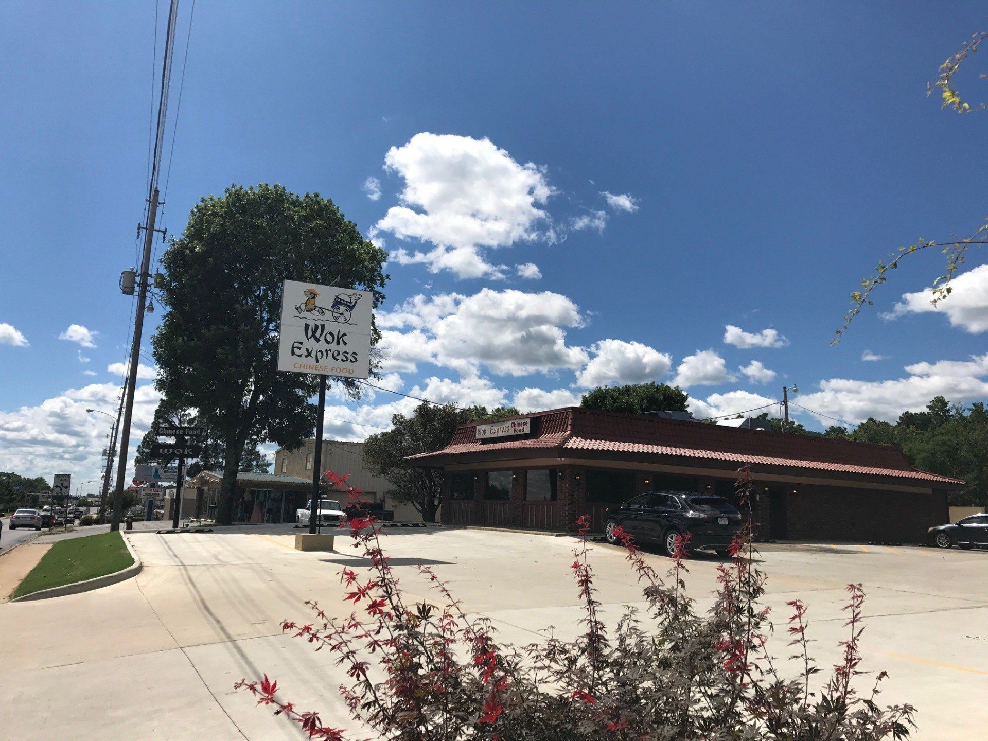 A restaurant with a sign that says ' wok chicken ' on it