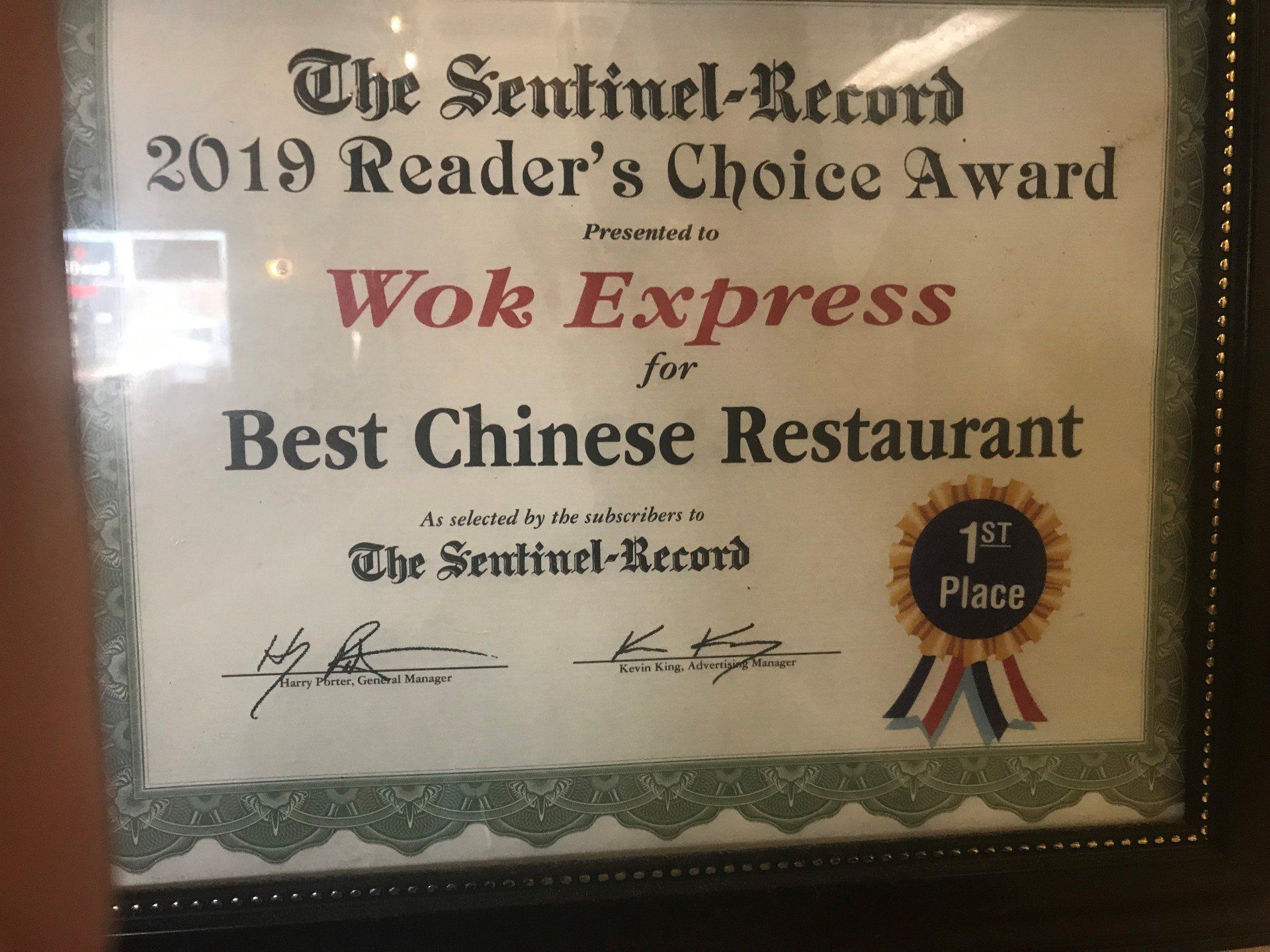 A framed certificate that says the sentinel record 2019 reader 's choice award for wok express for best chinese restaurant