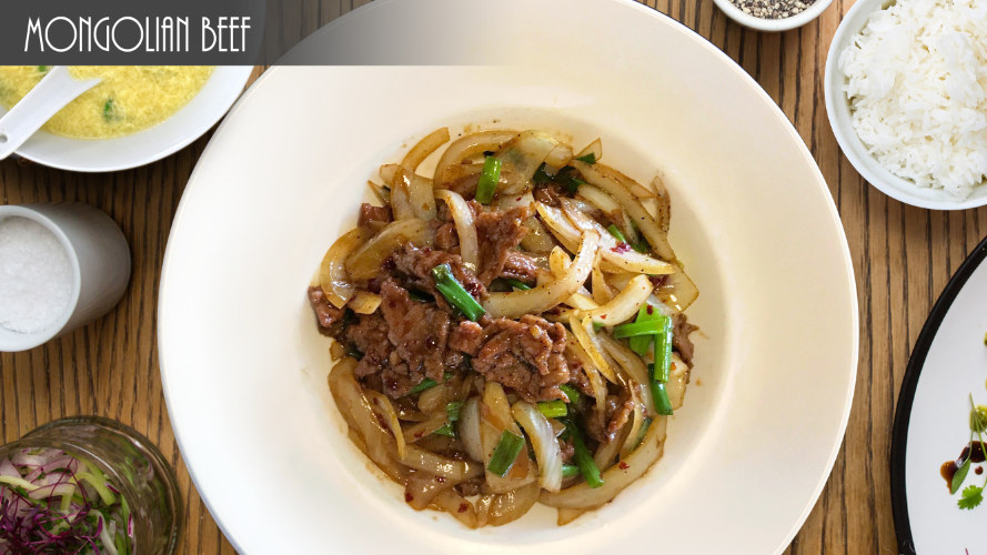 A plate of mongolian beef sits on a table