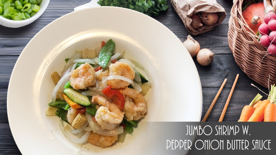 A plate of jumbo shrimp with pepper onion butter sauce