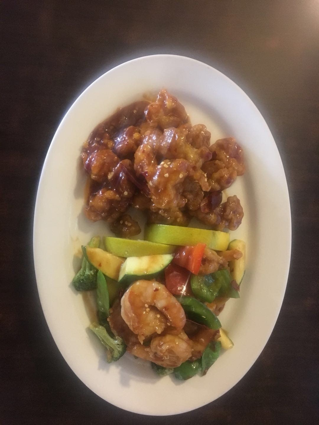 A plate of food with shrimp and vegetables on a table